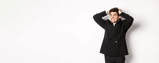 A stock image of a business executive looking worried and holding their head in their hands, with a financial chart showing a downward trend in the background. This symbolizes the financial stress caused by data breach fines.