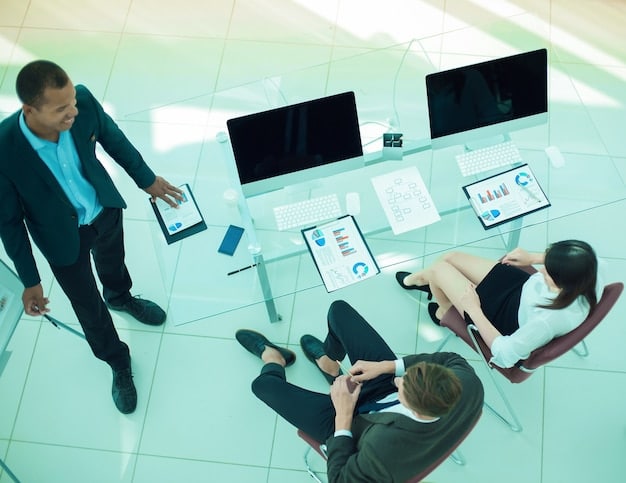 An image depicting employees participating in a cybersecurity training session, with screens showing examples of phishing emails and tips for identifying threats, emphasizing the importance of human awareness.