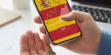 Mano sosteniendo móvil con gráfico bursátil y monedas de euro, simbolizando inversión accesible en acciones españolas.